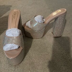 Brand new bedazzled wedged heels -never worn.  Size 7.5